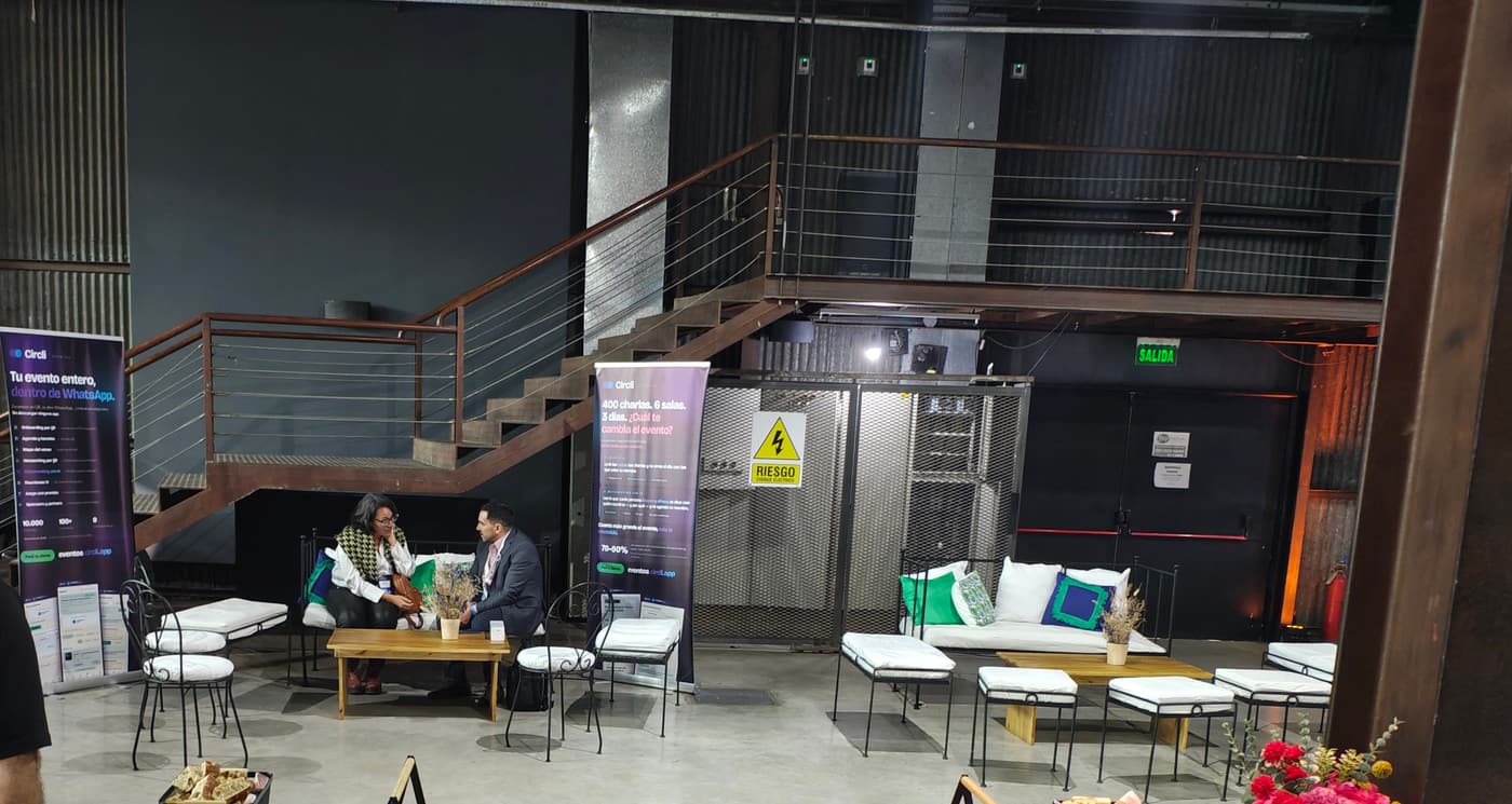 Networking area with two Circli pull-up banners, sofas and two people meeting at a low table