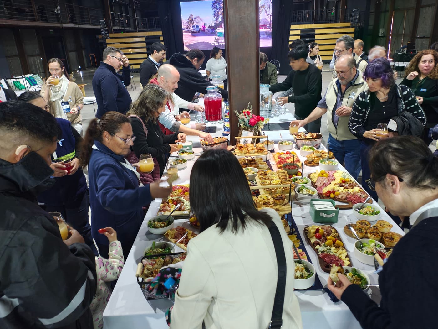 Attendees talking around the tables during the event's coffee break